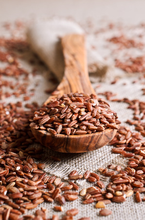 Whole raw grain unpolished brown rice in a potの写真素材