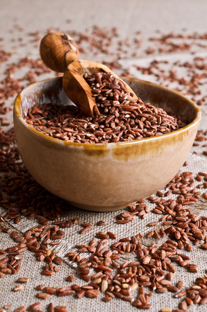 Whole raw grain unpolished brown rice in a potの写真素材