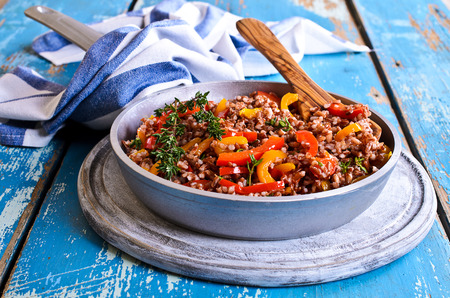 Side dish of red rice with paprika and thymeの写真素材