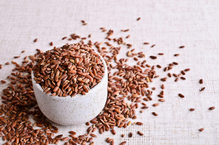 Brown unpolished rice in a ceramic bowlの写真素材