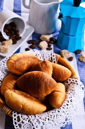 Croissants in a wicker basket with lace on the clothの写真素材