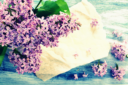 Background with lilac flowers painted on a wooden surfaceの写真素材