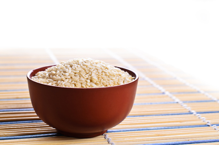 Seeds white sesame  lie in a ceramic dishの写真素材