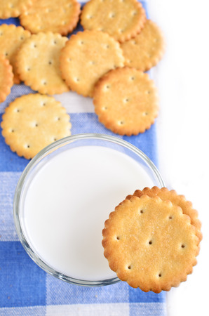 Cookies and milk on the checkered napkin on white backgroundの写真素材