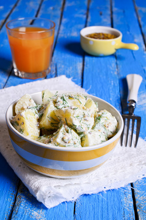 Potato salad with mustard seeds and white filling in rustic styleの写真素材