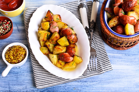 Potatoes with sausages, cut into slices and fried in oil, in rustic styleの写真素材