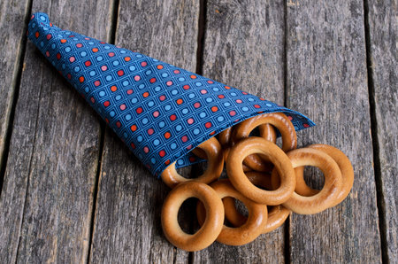 Pastry round shape with a hole in paper bags on a wooden surfaceの写真素材
