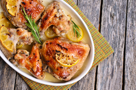 Chicken baked with lemon, mustard and rosemaryの写真素材