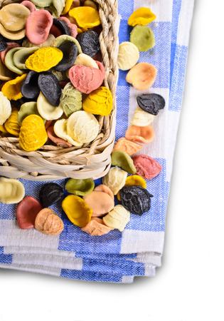Orecchiette different flowers in wicker basket on white backgroundoの写真素材
