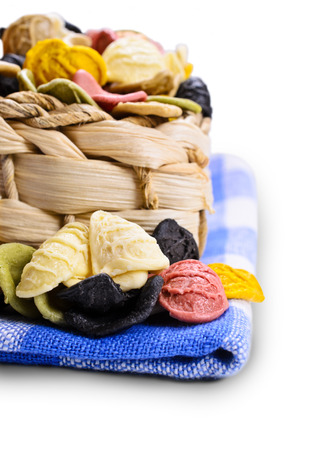 Orecchiette different flowers in wicker basket on white backgroundの写真素材