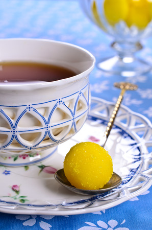 Yellow candy in sugar, round shape. Selective focus.の写真素材