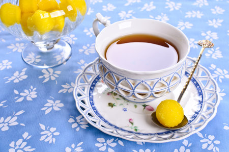 Yellow candy in sugar, round shape. Selective focus.の写真素材