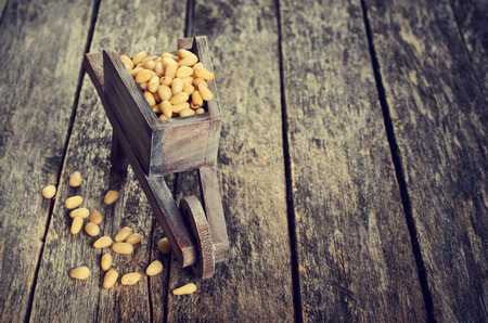 Pine nuts peeled on wood furniture in rustic styleの写真素材