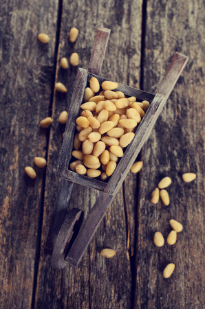 Pine nuts peeled on wood furniture in rustic styleの写真素材