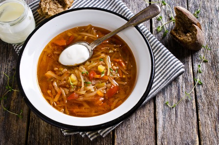 Soup with vegetables and sour cream on the plate. Selective focus.の写真素材