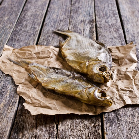 Dry fish bream with salt on a wooden surface. Selective focus.の写真素材