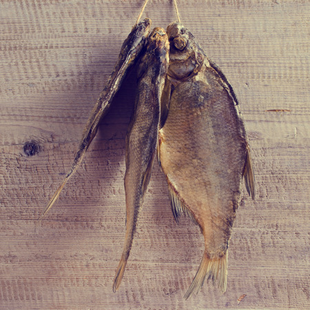 Dry fish bream with salt on a wooden surface. Selective focus.の写真素材