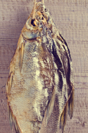Dry fish bream with salt on a wooden surface. Selective focus.の写真素材