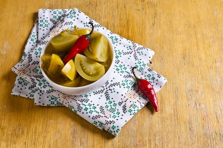 Canned green tomatoes, cut into pieces. Selective focus.の写真素材