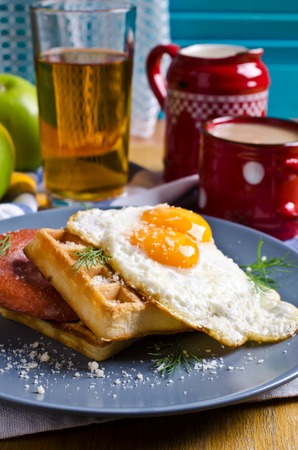 Waffles with sausage, eggs and cheese in the plate. Selective focusの写真素材