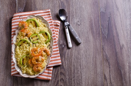 Fried shrimp on skewers with couscous and vegetables. Selective focus.の写真素材