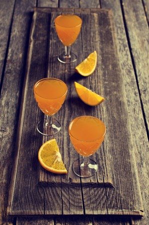 Cocktail citrus orange in a glass on a wooden surface. Selective focus.の写真素材