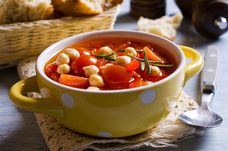 Clear soup with vegetables and chickpeas. Selective focus.の写真素材