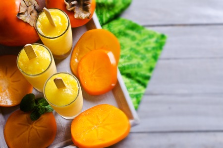 Homemade fruit ice pop with persimmon and mint. Selective focus.の写真素材
