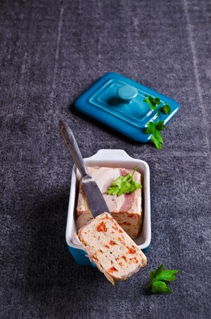 Meat terrine with bacon and paprika on a dark background. Selective focus.の写真素材