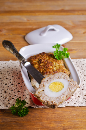 Meat Loaf with boiled egg on a wooden background. Selective focus.の写真素材