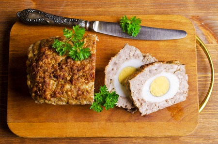Meat Loaf with boiled egg on a wooden background. Selective focus.の写真素材