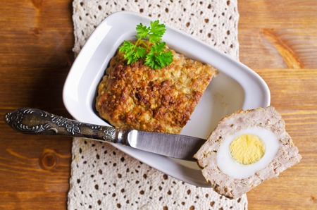 Meat Loaf with boiled egg on a wooden background. Selective focus.の写真素材