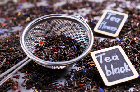 Dry black tea with flower petals. Selective focus.の写真素材