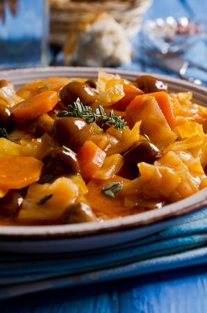 Vegetables with mushrooms stewed in a ceramic plate. Selective focus.の写真素材