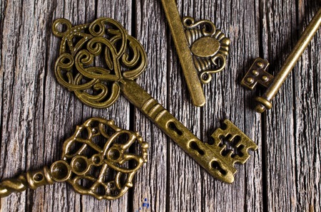 Vintage metal key on a wooden background. Selective focus.の写真素材