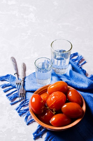 Homemade canned tomatoes in brine on the table. Selective focus.の写真素材
