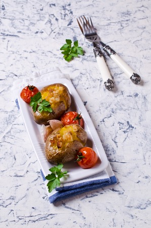 Homemade baked potato with bacon and vegetables. Selective focus.の写真素材