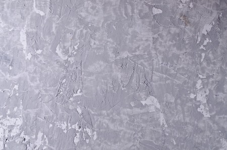 Gray concrete background with cracks and irregularities. Selective focus.の写真素材