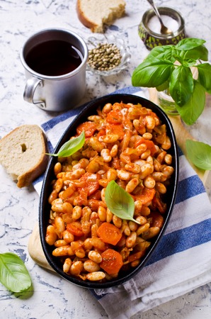 Baked beans in sauce with vegetables in rustic style. Selective focus.の写真素材