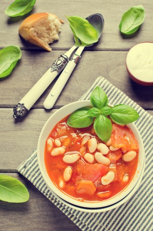 Thick soup with beans and vegetables on a wooden background. Selective focus.の写真素材