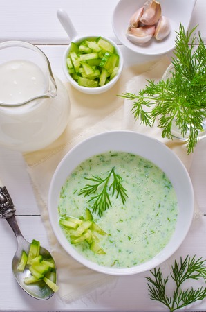 Traditional cold soup of cucumber on a wooden background. Selective focus.の写真素材
