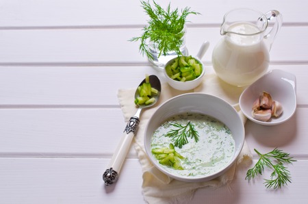 Traditional cold soup of cucumber on a wooden background. Selective focus.の写真素材
