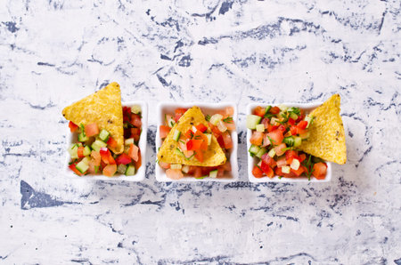Fresh homemade salsa with vegetables and chips nachos. Selective focus.の写真素材