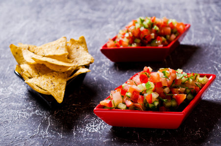 Fresh homemade salsa with vegetables and chips nachos. Selective focus.の写真素材
