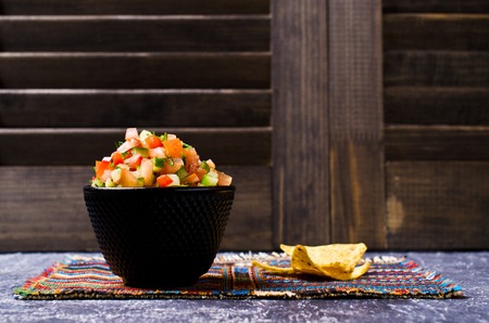 Fresh homemade salsa with vegetables and chips nachos. Selective focus.の写真素材
