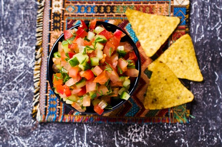 Fresh homemade salsa with vegetables and chips nachos. Selective focus.の写真素材