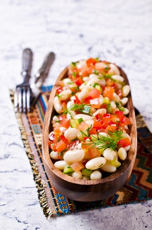 Salad with beans and vegetables in rustic style on a concrete background. Selective focus.の写真素材