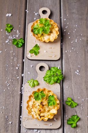 Homemade tartlets with cabbage on a wooden background. Selective focus.の写真素材