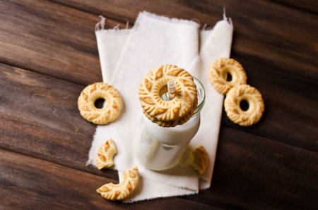 Round cookies with an ornament on a dark wooden background. Selective focus.