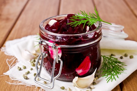 Canned beet slices in a glass on a wooden background. Selective focus.の写真素材